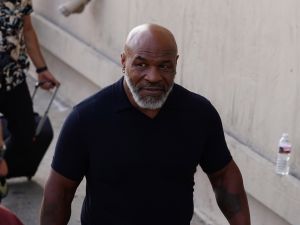 Mike Tyson walking down the street in black t-shirt