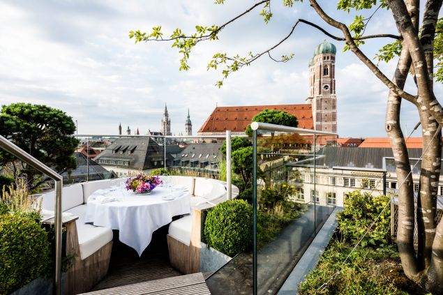 Rooftop terrace table overlooking city views.