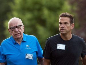 Rupert Murdoch, wearing a blue polo, walks next to Lachlan Murdoch, wearing a black t-shirt