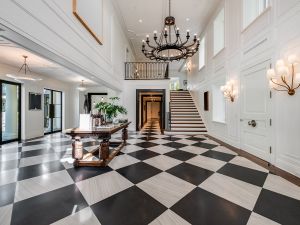 entry of mansion with black and white floors