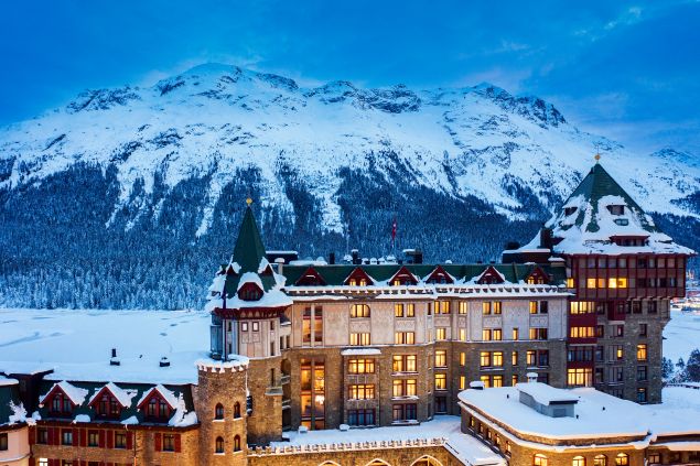 exterior of badrutt's palace hotel in st moritz switzerland in front of snow capped mountains