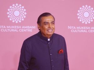 Reliance Industries chairman Muskesh Ambani in front of a pink banner at the launch of the Nita Mukesh Ambani Cultrual Centre
