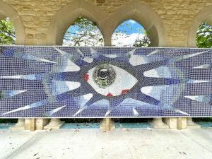 Swimming pool mosaic of eye surrounded by blue psychedlic designs