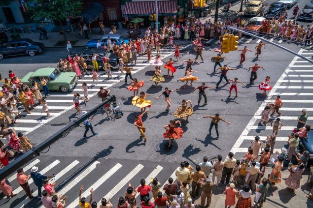Dancers flock the streets in different colors for the dance scene of West Side Story.