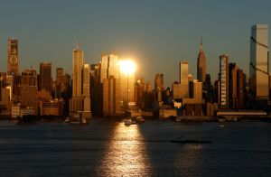 WEEHAWKEN, NJ - MAY 19: The sun sets on the skyline of midtown Manhattan and the Empire State Building in New York City on May 19, 2024, as seen from Weehawken, New Jersey.