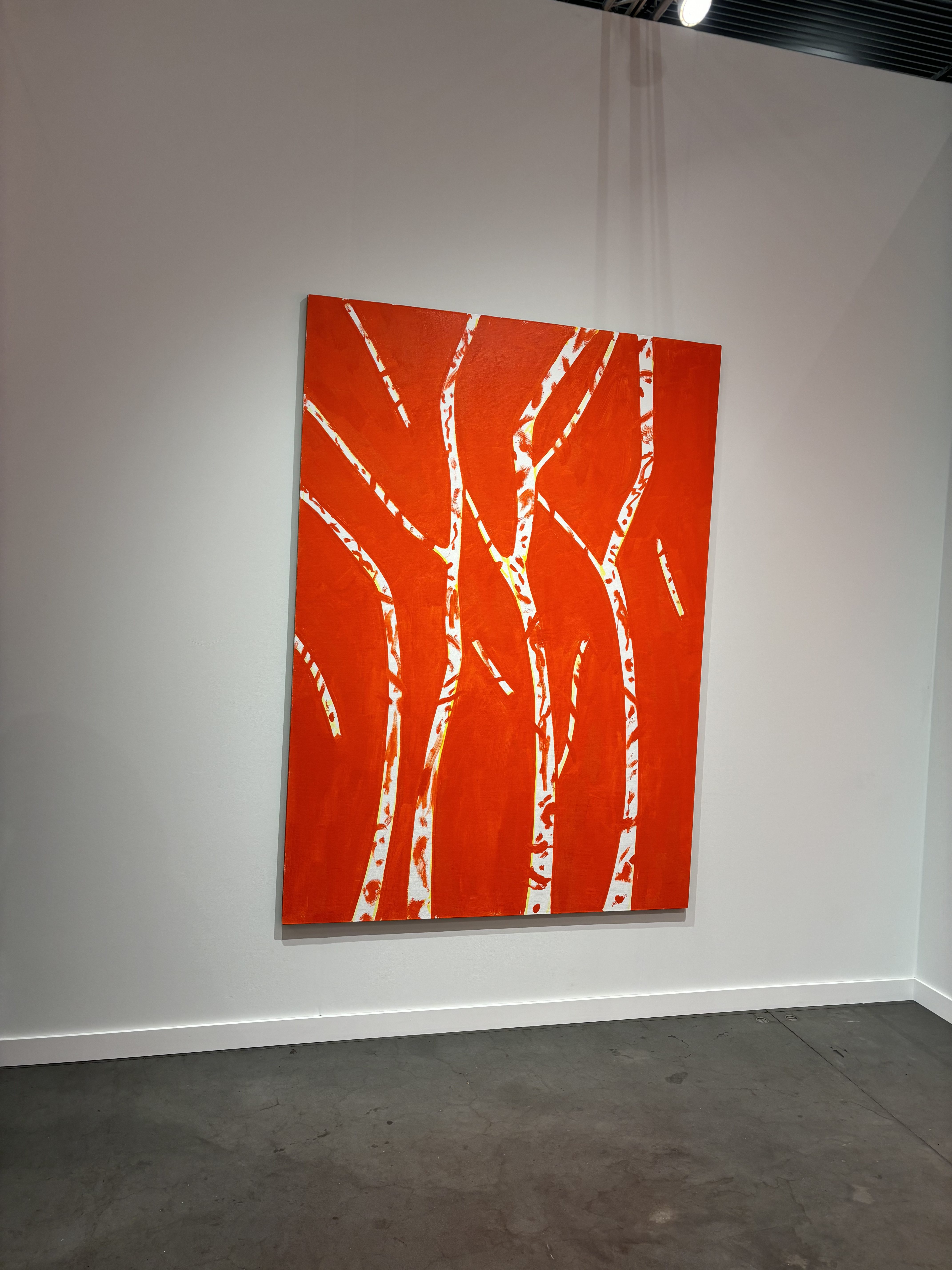 A painting of what looks like birch trees on a red baackground