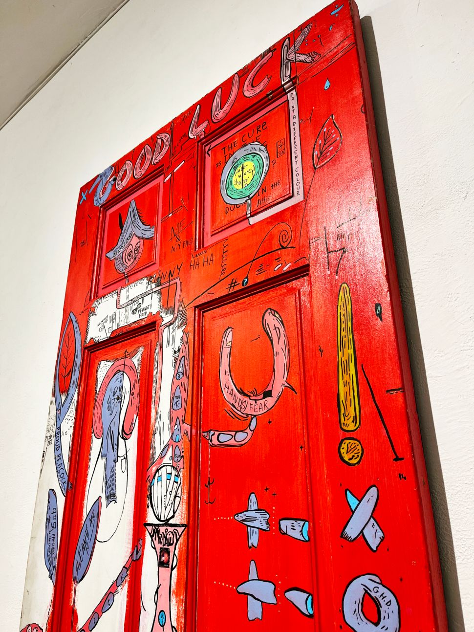 A red door painted with various motifs