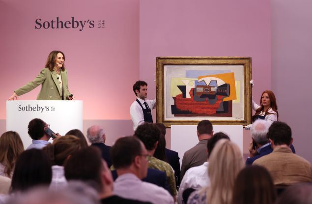 Woman Auctioner offering a Picasso's painting in an auction house.
