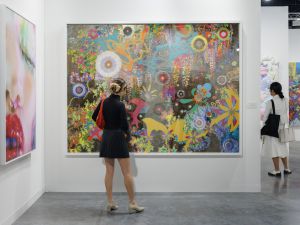 Young Collector in front of a painting at Art Basel