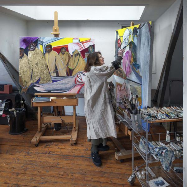 Jacqueline de Jong, painting in front of two canvas in her studio in Amsterdam.