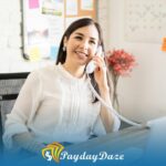 A woman sitting at a desk talking to an online lender on phone about the types of loans available in Las Vegas