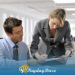 A man and a woman sitting at a desk in an office searching for payday loans in Jacksonville