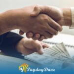 Two people shaking hands over a pile of money after getting payday loans in San Francisco