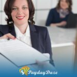 A woman sitting at a desk with a clipboard in front of her and explaining payday loans in Seattle