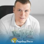 A man sitting at a desk with money from installment loans Arkansas in his hands