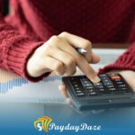 A person using a calculator on a desk to sum his Illinois installment loans