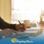 A man sitting at a desk calculating Iowa installment loans