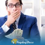 A man in a suit and tie holding a stack of installment loans money in Kentucky