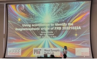 Kenzie Nimmo presenting this work at a recent conference. She's standing beneath a large screen that says "Using scintillation to identify the magnetospheric origin of FRB 20221022A", holding a microphone.