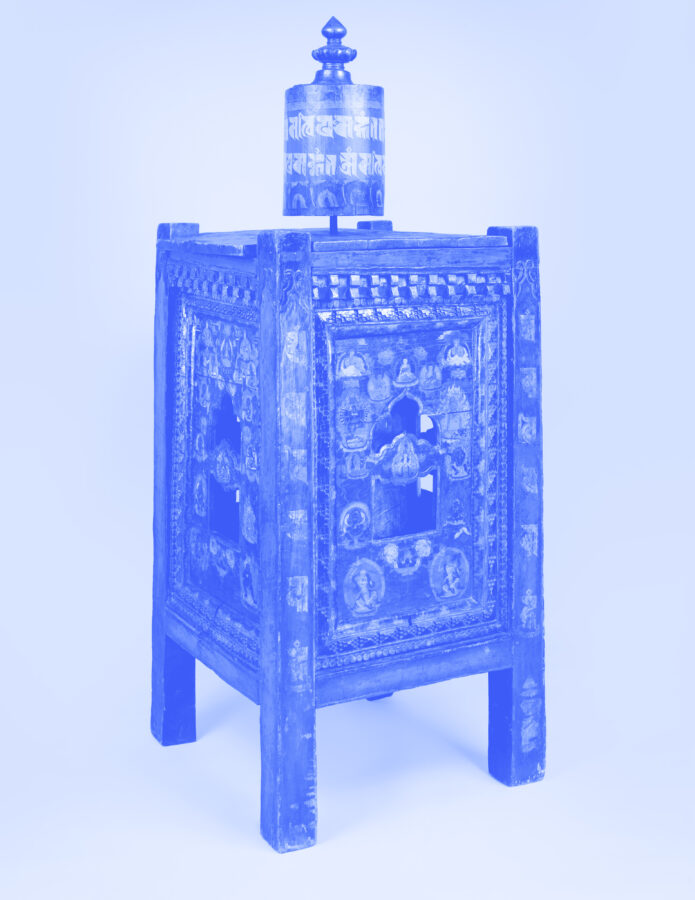 Blue image of cylindrical wheel mounted atop ornately carved wooded box with legs.