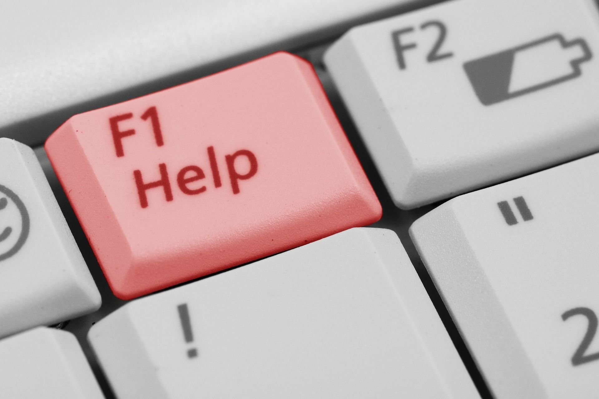 A small portion of a computer keyboard, mainly showing the F1 key with the word "Help" on it.