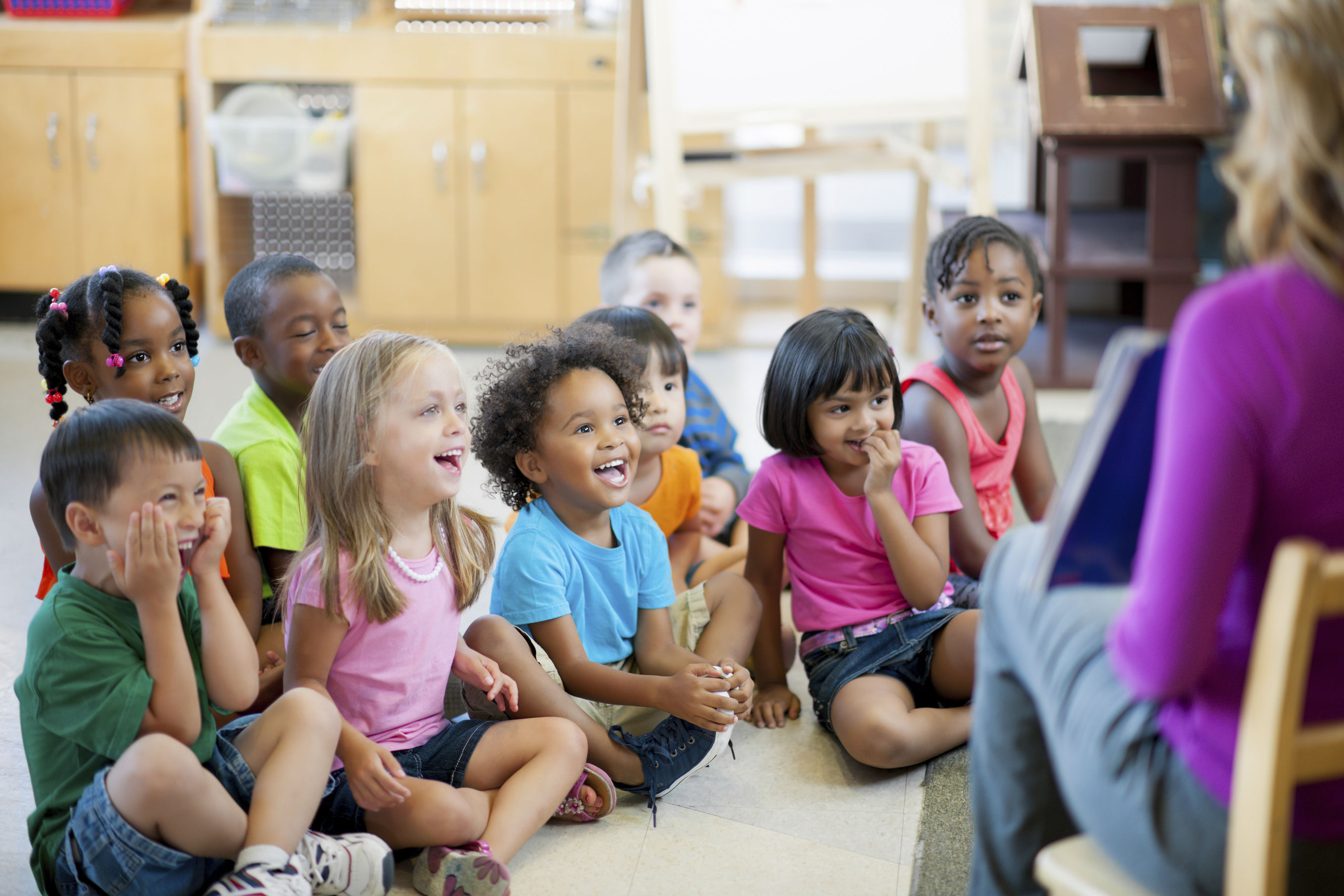 several seated children listening to a story