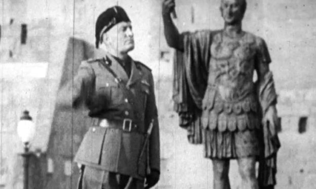 Benito Mussolini reviewing a military parade beside a statue of a Roman emperor, 1943, newsreel still