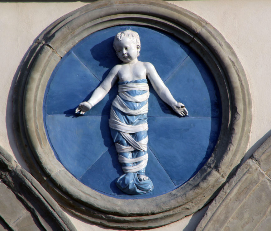 Andrea della Robbia, Infant in Swaddling Clothes, 1487, glazed terracotta, diameter about 100 cm. Ospedale degli Innocenti, Florence. Image: author.