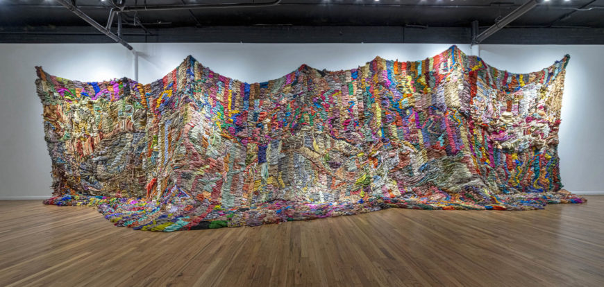 Suchitra Mattai, Exodus, 2019, vintage saris from India, Sharjah, artist’s Indo-Guyanese family and rope net, 15 x 40 ft (Collection of the Momentary, Crystal Bridges Museum of American Art)