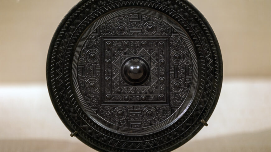 Mirror with game board design and animals of the four directions, 1st–2nd century C.E. (Han dynasty, China), bronze with black patina, 16.8 cm diameter (The Metropolitan Museum of Art, New York)