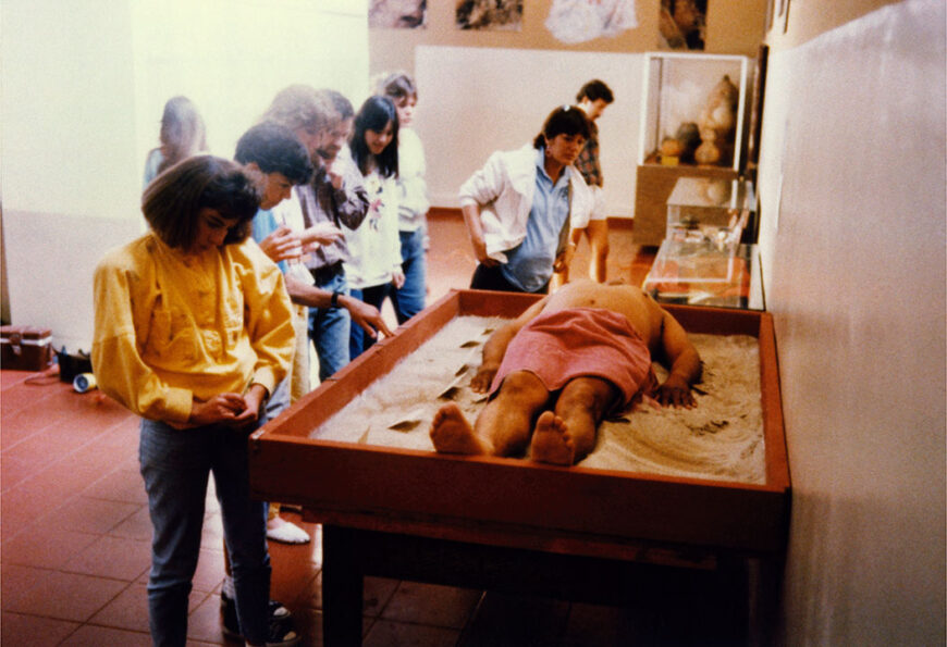 James Luna (Pooyukitchum/Luiseño) performing <em>Artifact Piece</em>, 1987, at the San Diego Museum of Man (Courtesy of the James Luna Estate, and Garth Greenan Gallery)