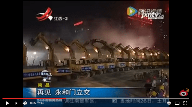 A hundred excavators line up along a road in China to make it disappear