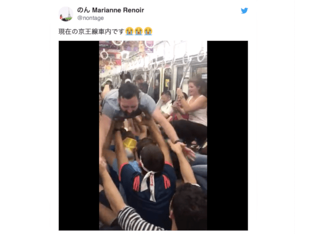 Rugby World Cup fans perform lineout on floor of a Japanese train