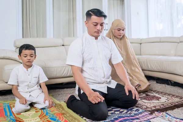 Young Muslim Family Praying Together Living Room Home Stock Photo