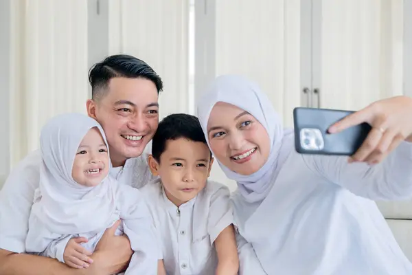 Happy Muslim Family Making Video Call Taking Selfie While Sitting Royalty Free Stock Images