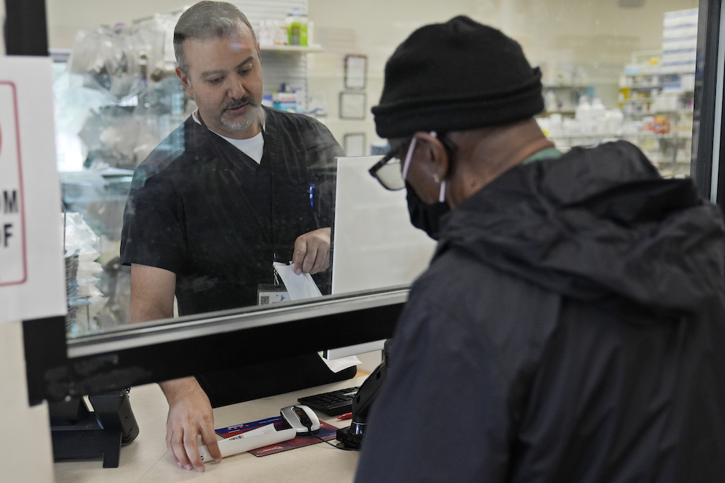 A pharmacist with a customer at a drug store.