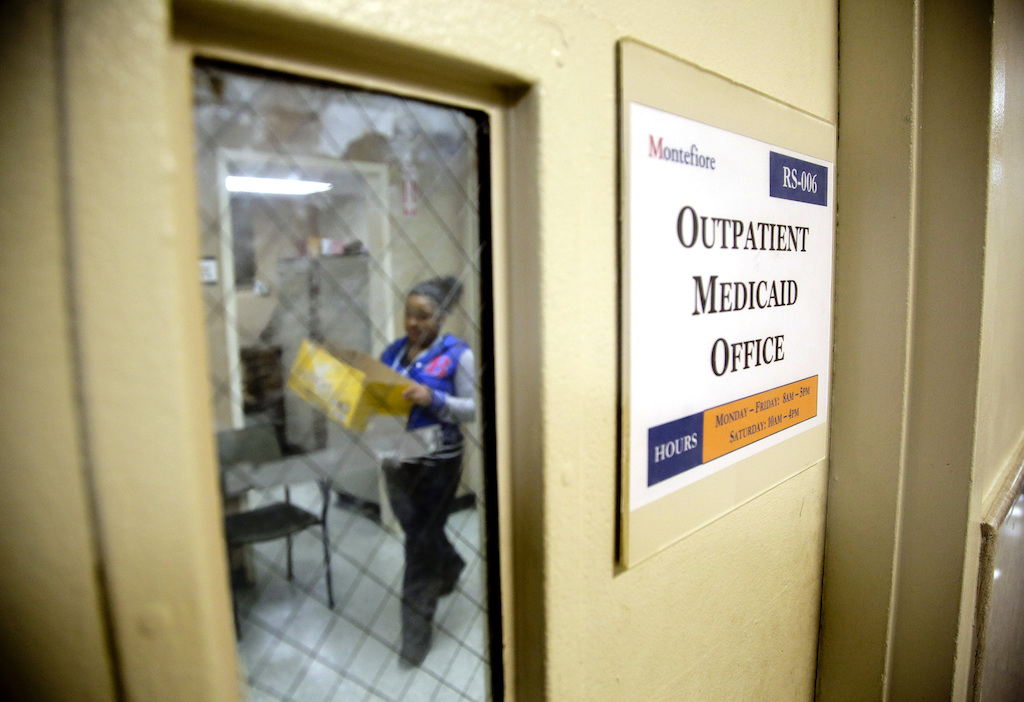 A Medicaid office employee carries reports.