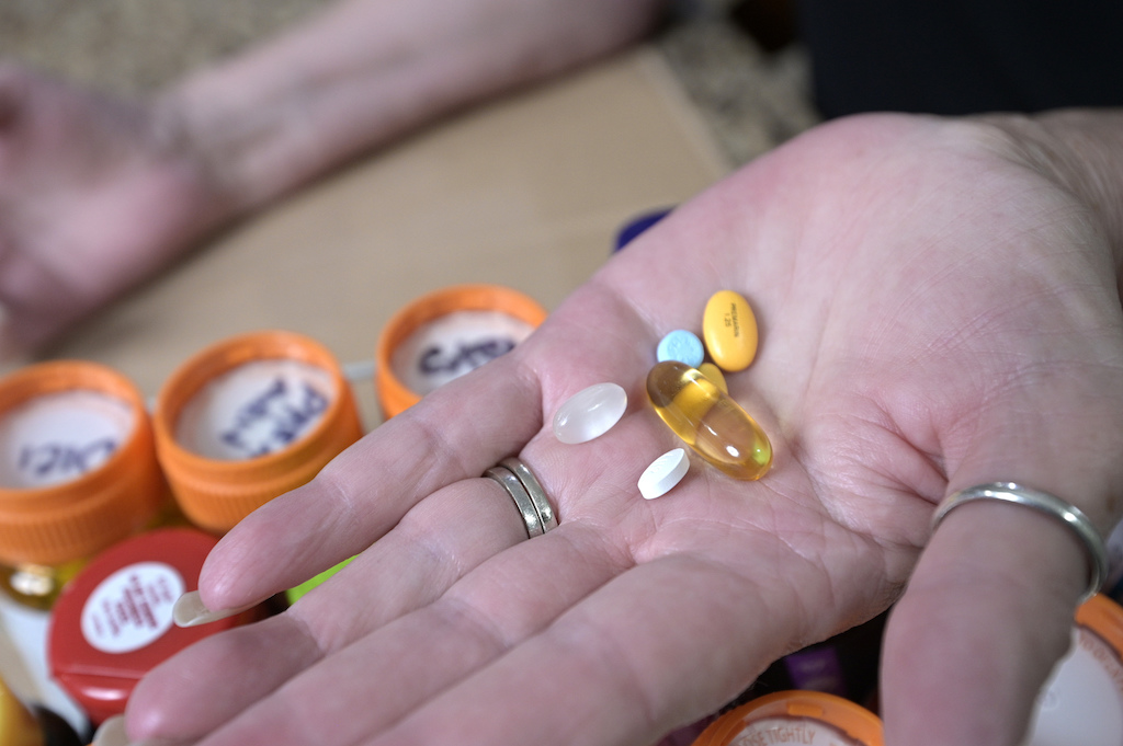 A woman holds some prescription drugs.