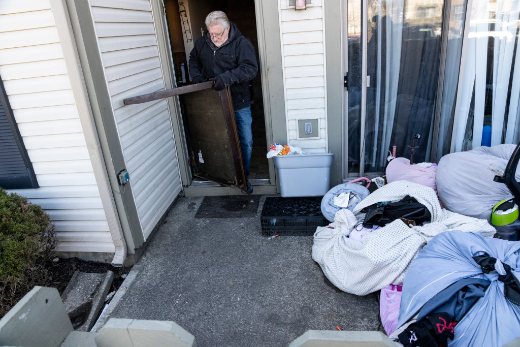 A worker removes belongings from a home during an eviction.