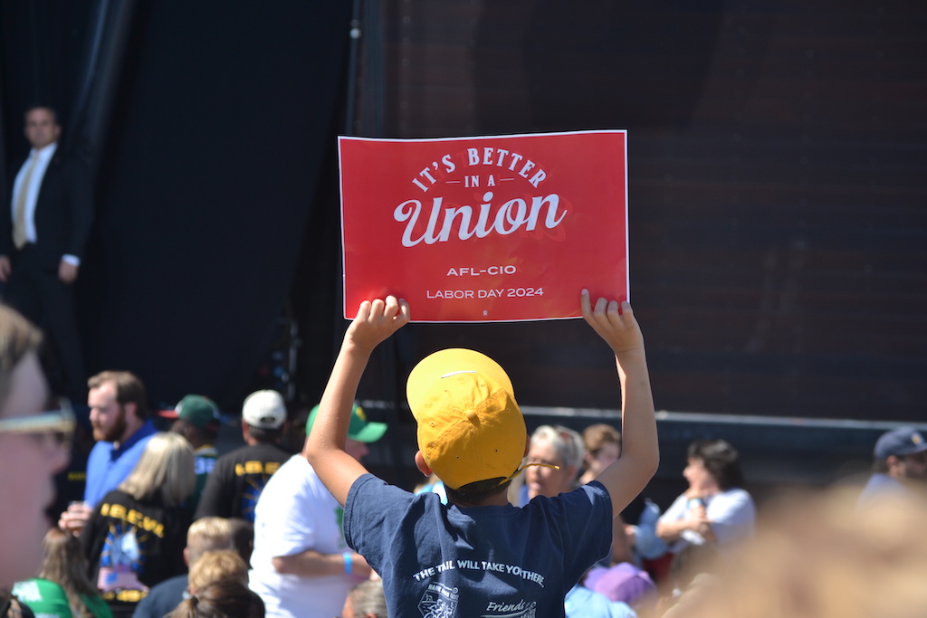 A youth holds up a sign.