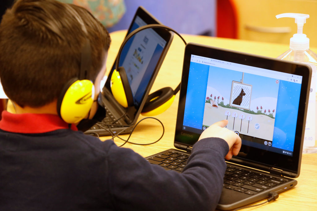 A student works on a computer at school.