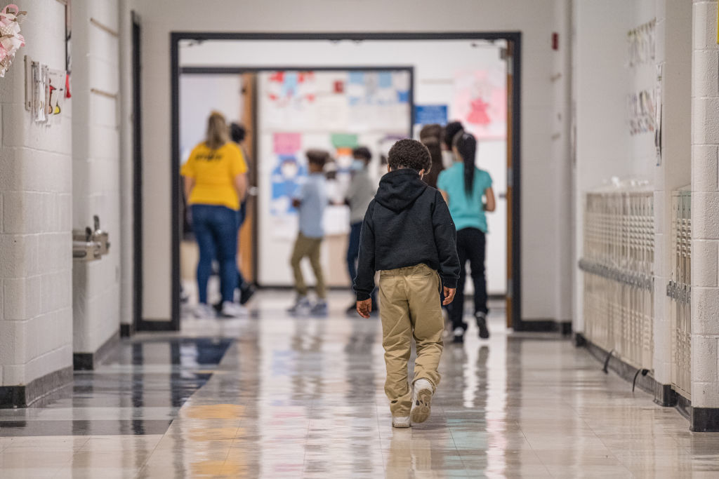 A child is seen in a school hallway.