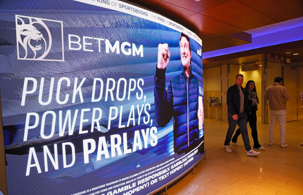 Fans walk past a BetMGM sign featuring Wayne Gretzky.