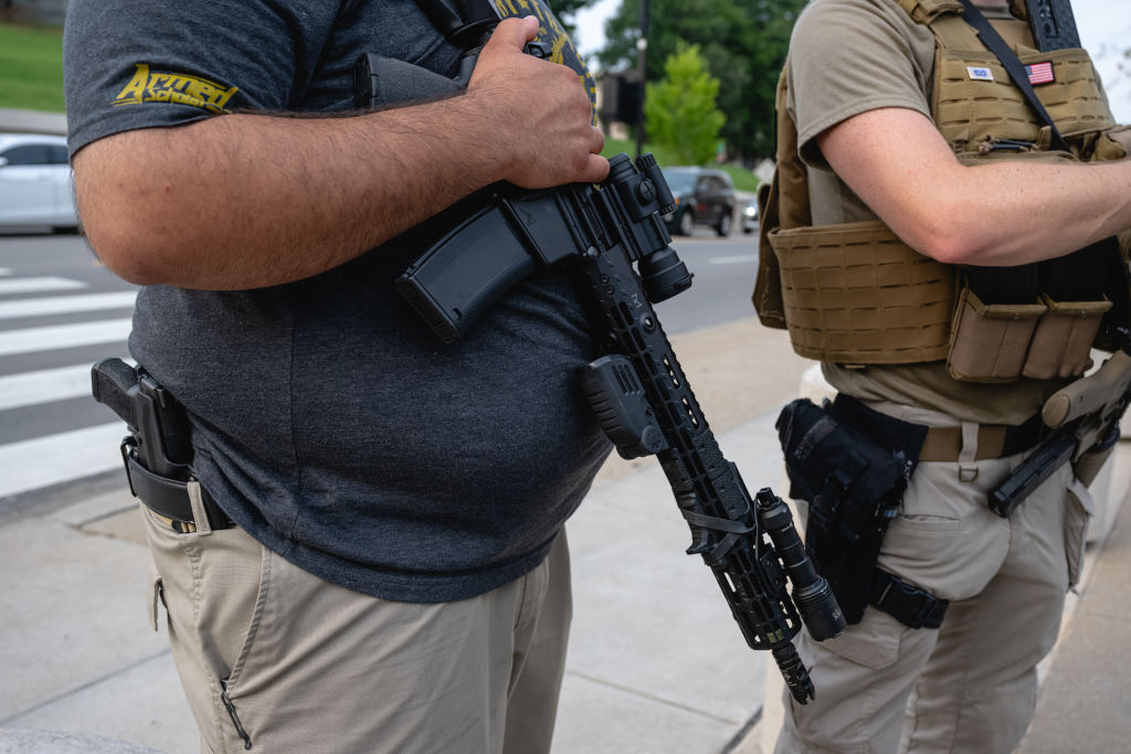 A man carries firearms outside the Tennessee Capitol.