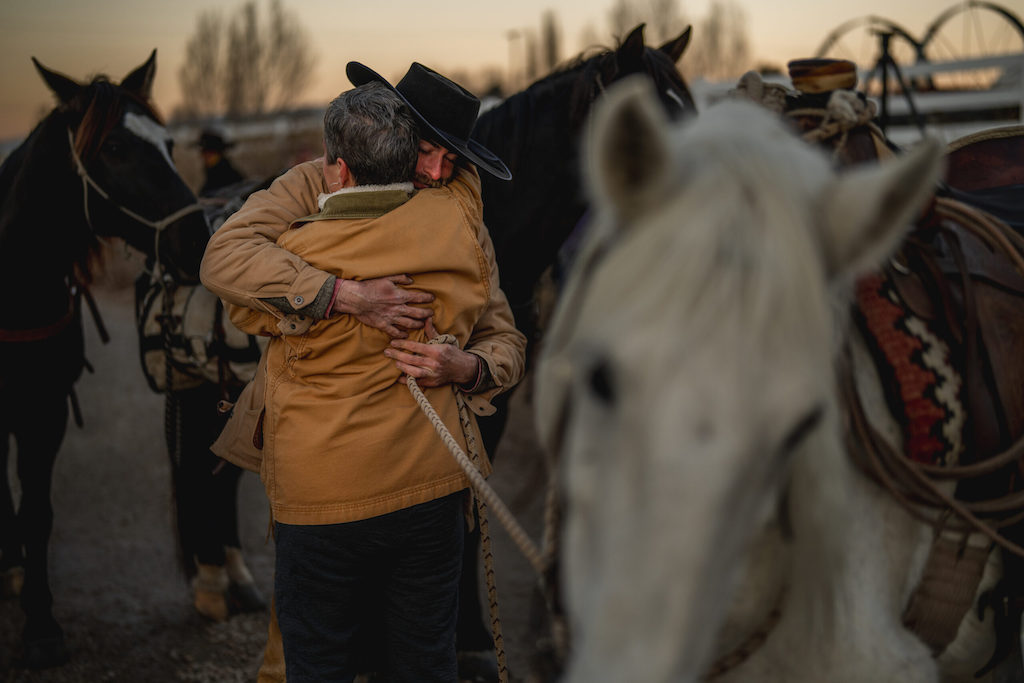 A man and woman hug.