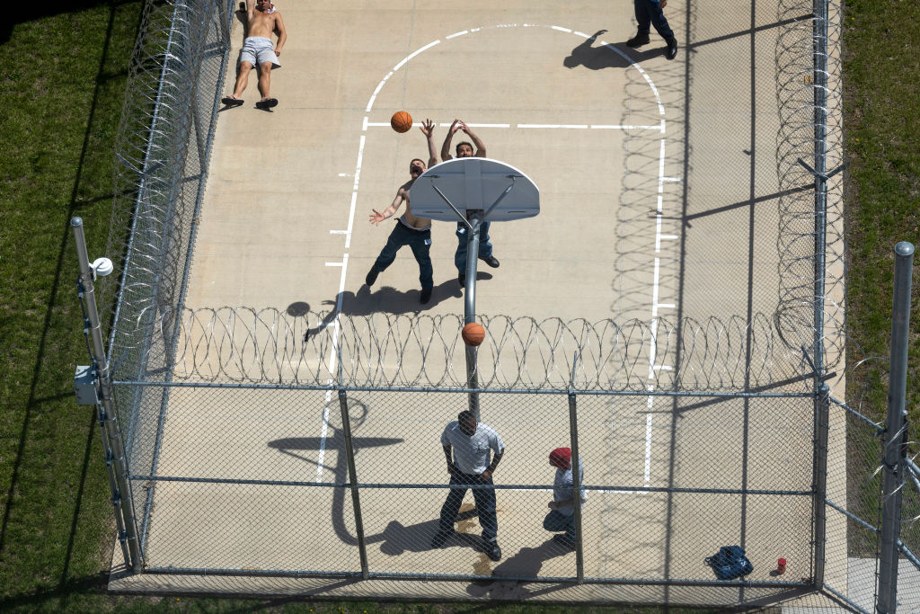 Inmates play basketball in a Kansas correctional facility.