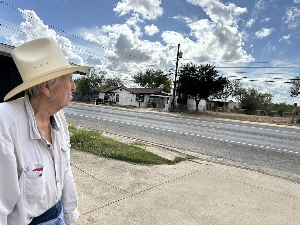 A man looks across a Texas highway.