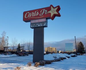 A sign at a fast-food restaurant advertises for workers.