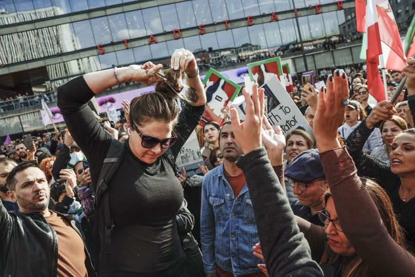 Demonstrators cut their hair in Stockholm, Sweden, September 2022.