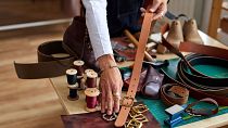 Craftsman working on a handmade leather belt